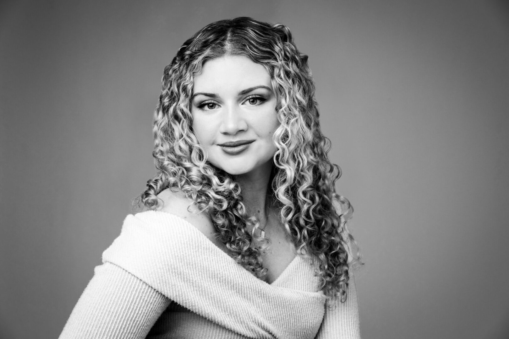 A woman with long hair and a white sweater.